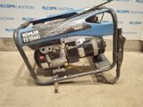 a close up of a small engine on a cart in a room