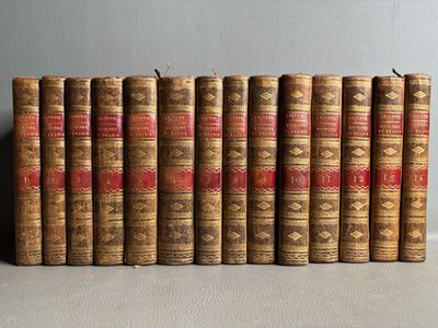 several old books lined up in a row on a table