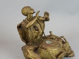 a statue of a man sitting on a turtle with a clock
