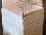 a small white cube with four squares on it