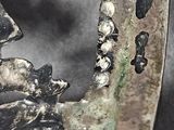 a close up of a metal object with skulls on it