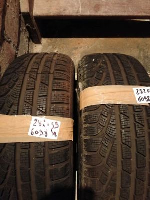 Deux pneus sont emballés et prêts à être rangés dans le garage