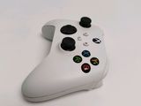 a close up of a white controller on a table