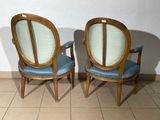 two chairs sitting next to each other on a tiled floor
