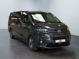 the black van is parked in a large room with a white wall