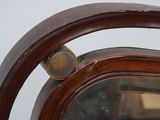 a close up of a mirror with a wooden frame