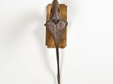 sculpture of a fish on a wall mounted on a wooden plaque