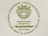 a white plate with a green and gold emblem on it