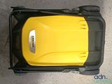 yellow and black lawn mower sitting on top of a cement floor