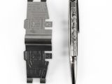 a pen and a watch sitting next to each other on a white surface