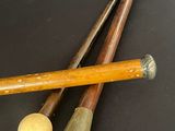 two baseball bats and a ball on a table