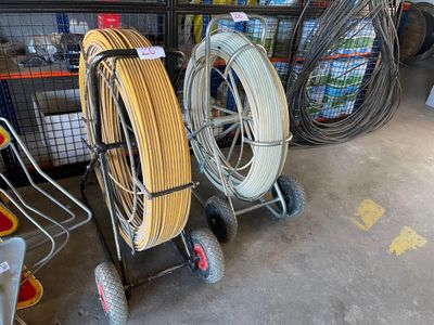 many different types of hoses and carts in a garage