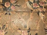 a very old wooden box with a floral design on it