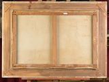 painting on easel in front of bookshelf with red curtain