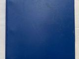 the blue book is open on a white surface with a white background