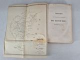 an open book with a map on it sitting on a table