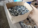a cardboard box filled with metal parts on a table