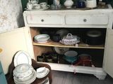 a cabinet with dishes and plates on it in the kitchen
