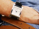 a man that is wearing a watch on his wrist