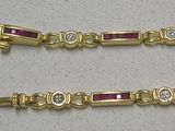 two gold bracelets with ruby stones and diamonds on them
