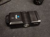 a small camera sitting on the floor next to a camera