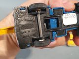 a person holding a toy car in their hand