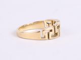 a close up of a gold ring on a white surface
