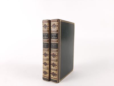 an old book sitting on top of a table next to a white wall