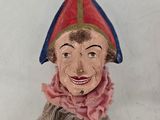 a statue of a man with a red hat and a pink scarf