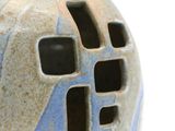 a close up of a vase with holes in it