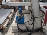a machine that is working on a piece of wood