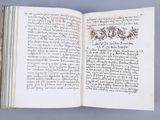 an open book with writing on it sitting on top of a table