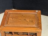 an old wooden side table with a carved top and legs