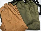 two pairs of green and brown pants sitting next to each other