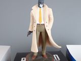 a figurine of a man in a trench coat on a table