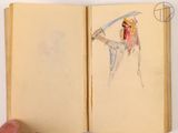 someone is holding a book with a drawing of a man holding a sword