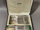 silver plated flatware in a case on a table