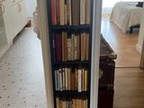 a book shelf with many books on it in a room