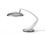 a white lamp that is sitting on a table