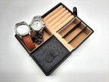 deux montres et un coffret à montres posés sur une table blanche