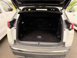 a white suv with its trunk open in a parking lot