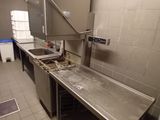 a kitchen with a sink, stove, and other items in it