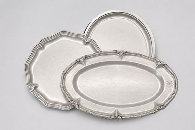 three silver trays on a white background