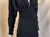 the mannequin is wearing a black dress on a white mannequin