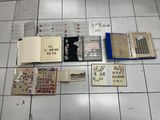 a lot of books on the floor with stamps on them