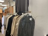 a lot of clothes hanging on a rack in a store