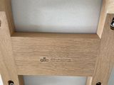a wooden chair that has a white cushion on top of it