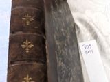 an old book that is sitting on a bed