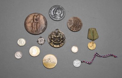 a lot of coins and a medal on a table