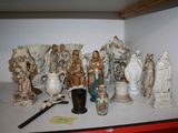 many figurines sitting on a shelf in a room